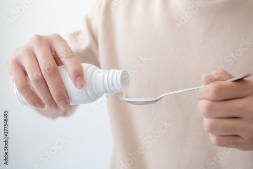 Men pouring drugs or antacids in their hands because of the food from their hands to the bottle. Concepts of health care, people and medicine