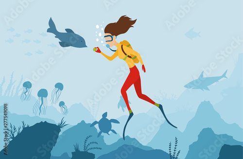 The girl diver playing with a dolphin. Scuba Diver. Underwater world. Girl dive on a coral reef. Summer vacation, sport active holidays. Underwater landscape with fish, corals and algae.
