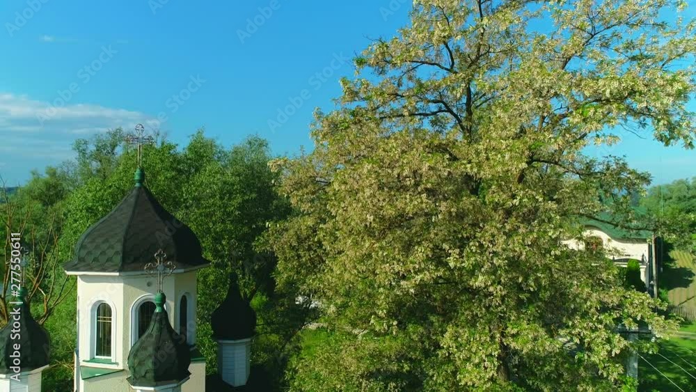 Aerial view of the church among spring tree blossom. 4K. Aerial view of the church among spring tree blossom. 4K.