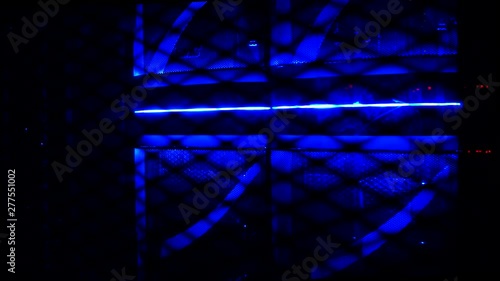 Blue computer server behind rack