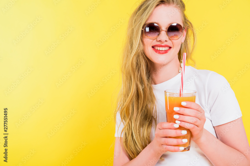 beautiful smiling girl with cocktail glass Isolated On yellow beautiful smiling girl with cocktail glass Isolated On yellow