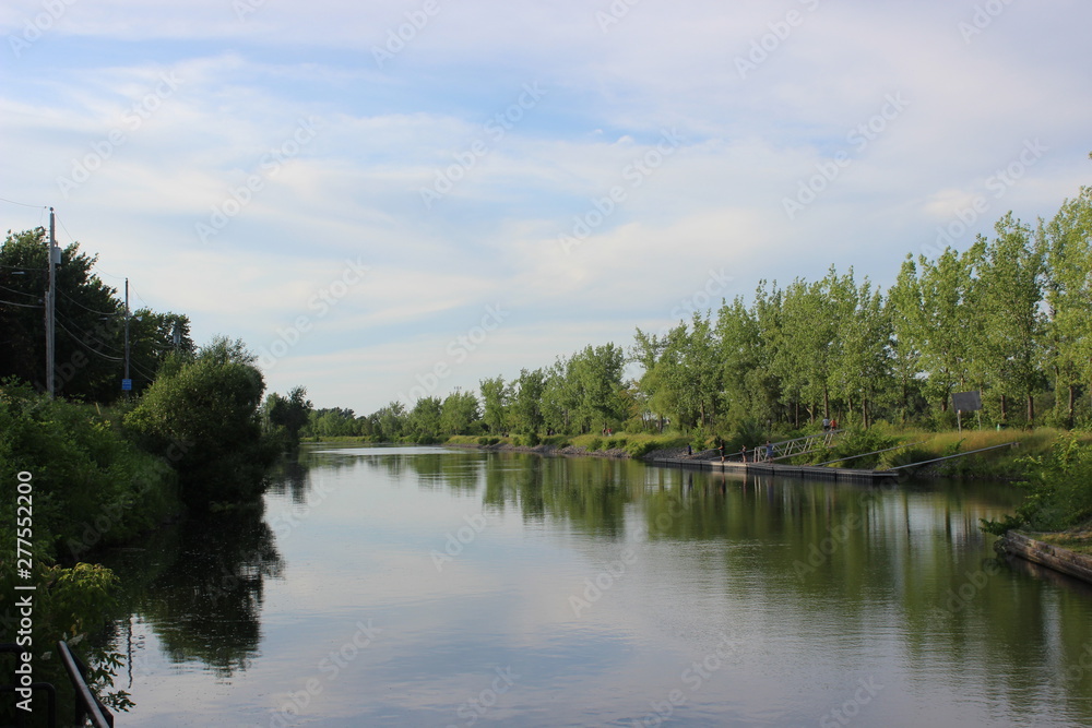 Historical Chambly Canal near St-Jean-sur-Richelieu, Quebec, Canada in summer with nature reflecting on the water Historical Chambly Canal near St-Jean-sur-Richelieu, Quebec, Canada in summer with nature reflecting on the water
