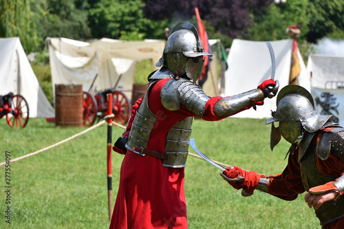 Fight of medieval Polish knights with sabres. Historical reenactment in Brodnowski park in Warsaw, Poland
