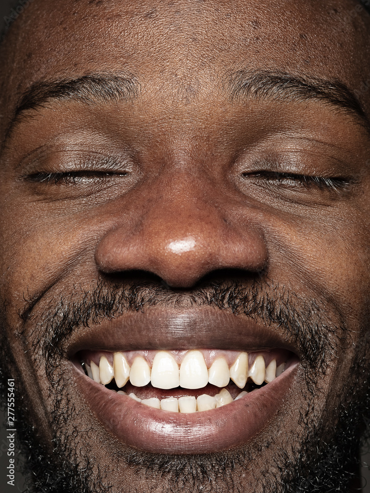 Fototapeta premium Close up portrait of young and emotional african-american man. Highly detail photoshot of male model with well-kept skin and bright facial expression. Concept of human emotions. Happy smiling.