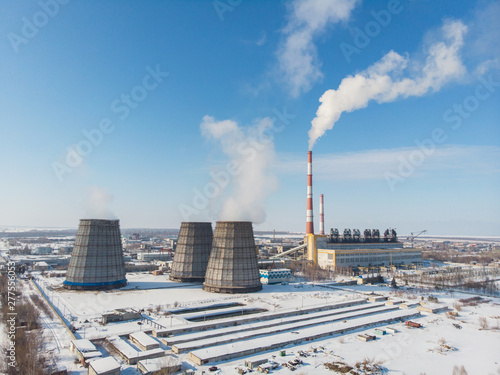 Landscape of smoking chimneys of factories in an industrial city  sunny beauty winter day. Concept of dangerous ecology in city  smoke and smog from factories and plants.