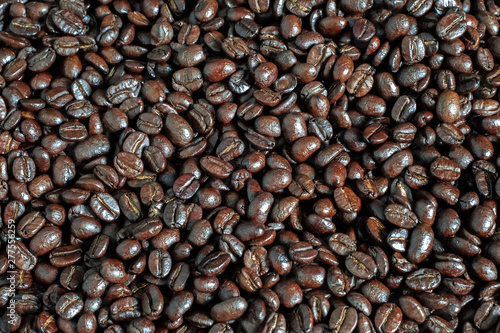 Brown roasted coffee beans  seed on dark background.