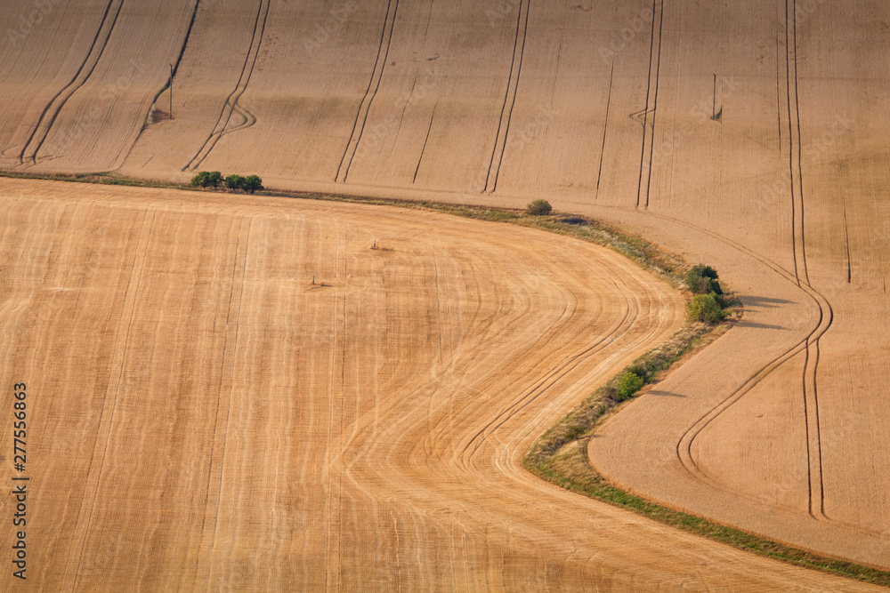 Agricultural summer. Natural Landscape In Brown And Yellow Colors of Ceske stredohori at the sunset, Czechia