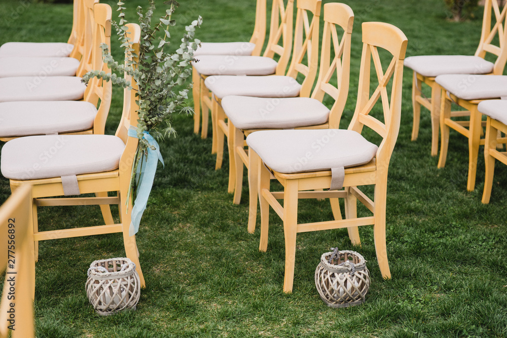 Fototapeta premium Coziness and style. Modern event design. Lounge zone and european traditional wedding ceremony decoration outdoors in the restaurant before the reception.