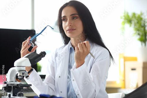 Female sciense chmist portrait aganist chemistry photo