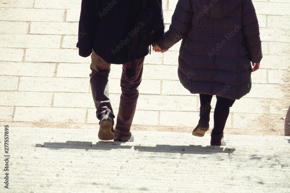Lover holding hand and walk step by step in autumn , romantic scene, together life. Lover holding hand and walk step by step in autumn , romantic scene, together life.