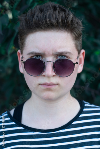 Girl in sunglasses with short hair, gender equality portrait,