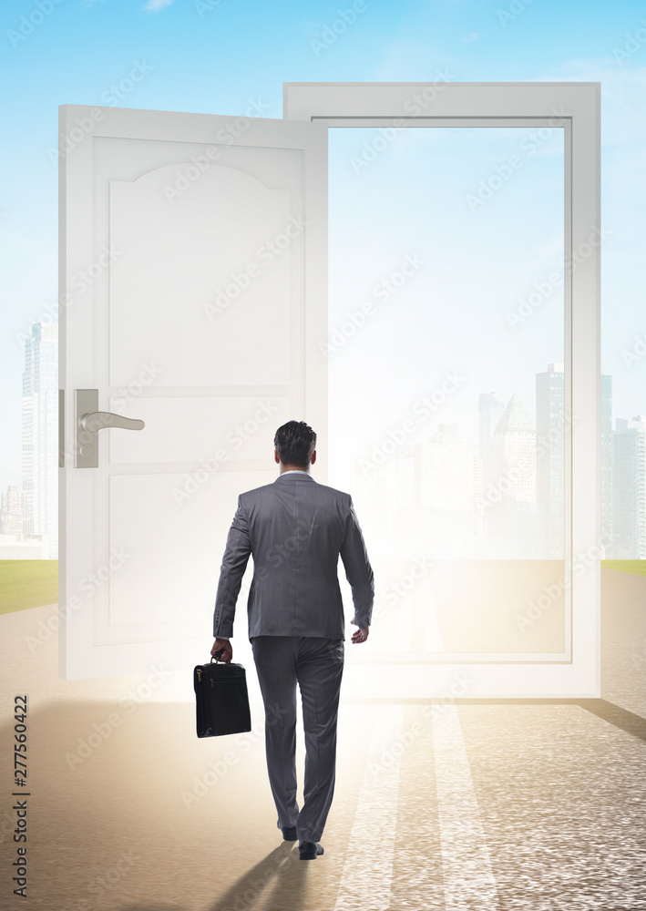 Businessman in front of door in business opportunities concept Businessman in front of door in business opportunities concept