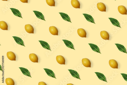 Summer exotic pattern with lemon and green leaves on the minimal background. Citrus wallpaper