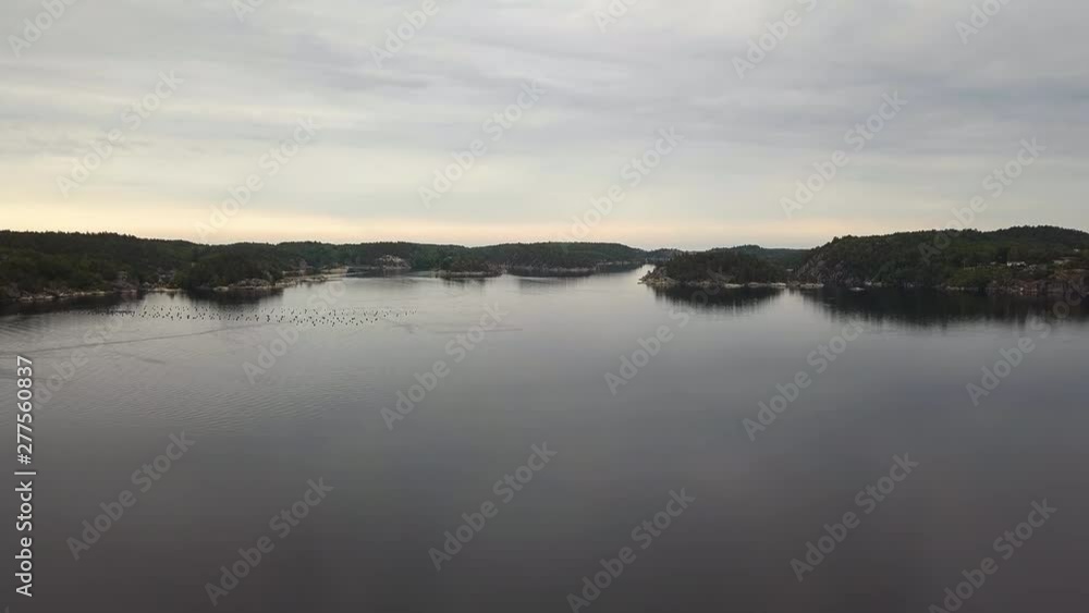 Aerial, rising, drone shot, over Kaldvellfjorden, at Kaldvell, on a cloudy day, in Lillesand, Norway Aerial, rising, drone shot, over Kaldvellfjorden, at Kaldvell, on a cloudy day, in Lillesand, Norway