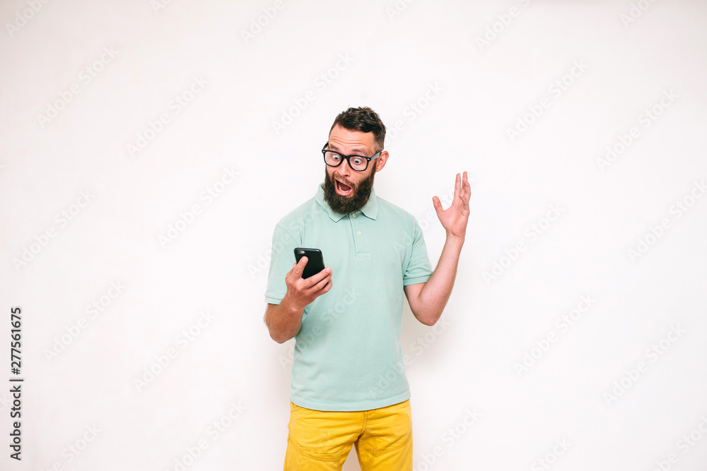 Portrait of young man looking at mobile phone isolated over white background, Portrait of young man looking at mobile phone isolated over white background,
