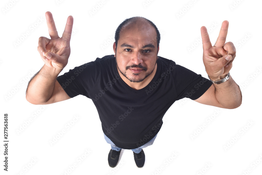 Latin american man making the victory sign on a white background Latin american man making the victory sign on a white background