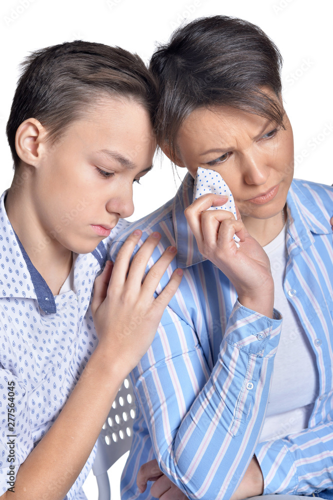 Sad mother and son posing on white background Sad mother and son posing on white background