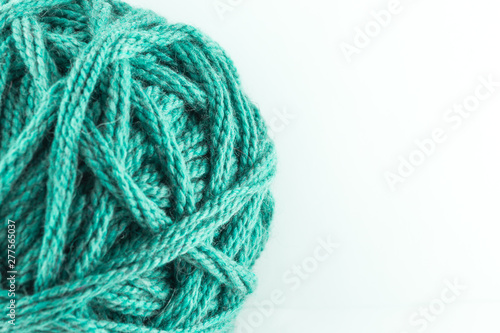 A large ball of green wool. Cozy accessories. Materials for knitting.