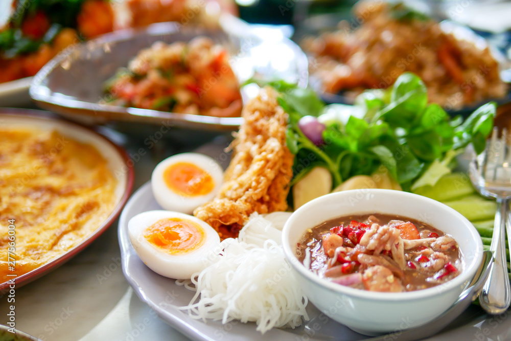 Southern of Thai food that delicious and spicy with variety of menu that placed on the marble table, top view Southern of Thai food that delicious and spicy with variety of menu that placed on the marble table, top view