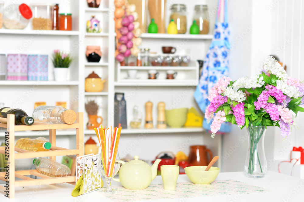 Yellow tableware and flowers on a kitchen table Yellow tableware and flowers on a kitchen table