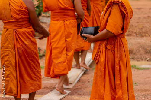 There was a merit making in the morning. People would scoop food into the alms of many monks.