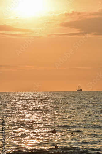 Golden Sunset at the Beach with Ship © LaDonna