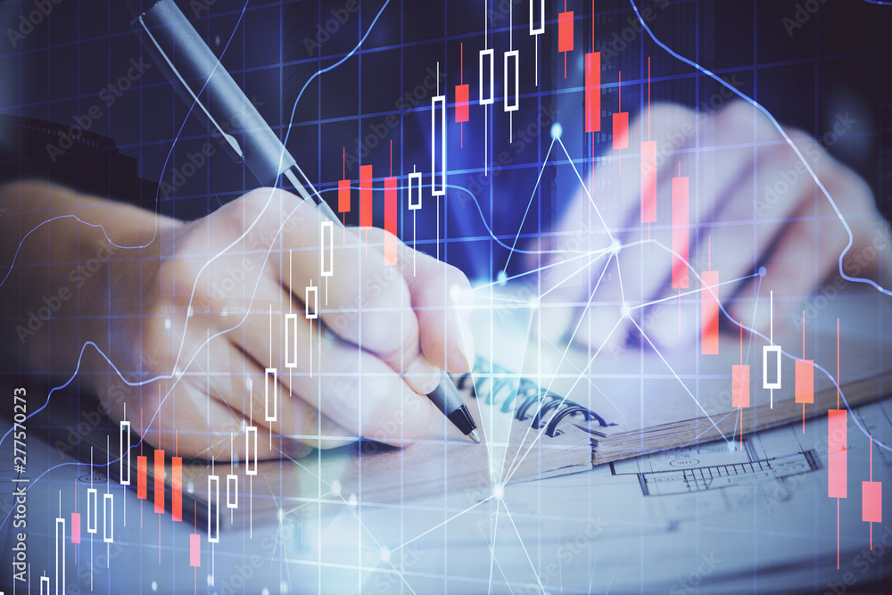 Forex graph on hand taking notes background. Concept of research. Double exposure Forex graph on hand taking notes background. Concept of research. Double exposure