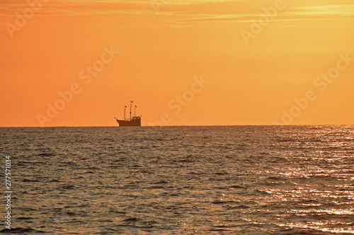 Golden Sunset at the Beach with Boat © LaDonna