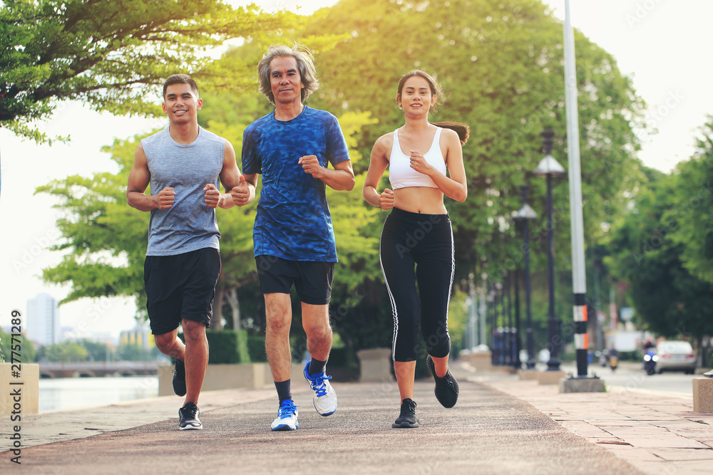 An old man in Asia is jogging with his son and daughter in the morning. An old man in Asia is jogging with his son and daughter in the morning.