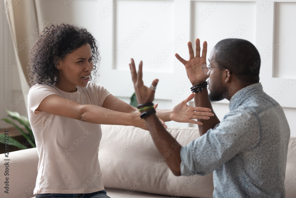 Angry stressed young african couple arguing shouting at home Angry stressed young african couple arguing shouting at home
