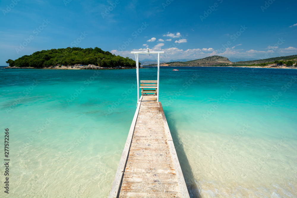 wooden pier on paradise beach in Ksamil in Albania