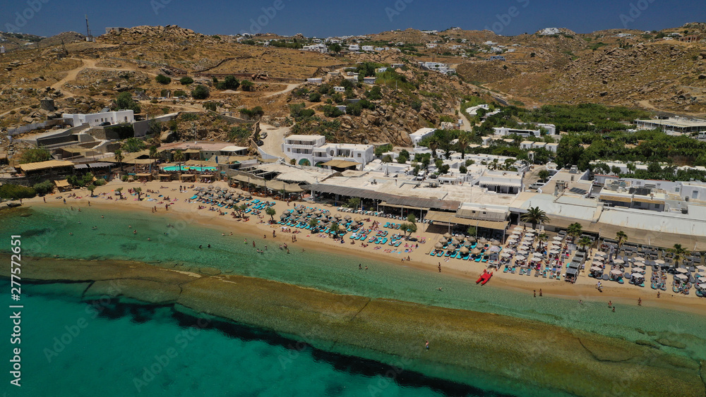 Aerial drone photo of famous organised with sun beds and umbrellas beach of  Paradise with emerald clear sandy sea shore, Mykonos island, Cyclades, Greece  