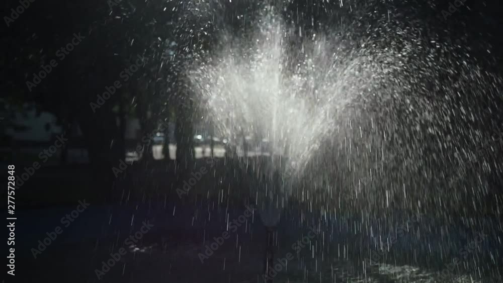 Fountain in City Park. slow motion. Panning shot, high contrast sun light, Fountain in City Park. slow motion. Panning shot, high contrast sun light,