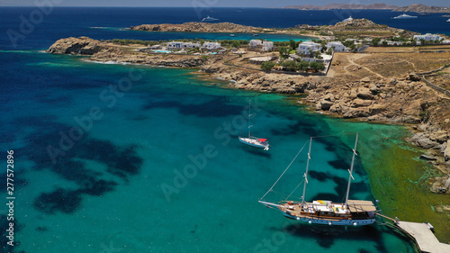 Aerial drone photo of famous organised with sun beds and umbrellas beach of  Paradise with emerald clear sandy sea shore, Mykonos island, Cyclades, Greece   photo