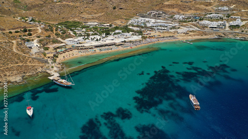 Aerial drone photo of famous organised with sun beds and umbrellas beach of  Paradise with emerald clear sandy sea shore, Mykonos island, Cyclades, Greece   photo