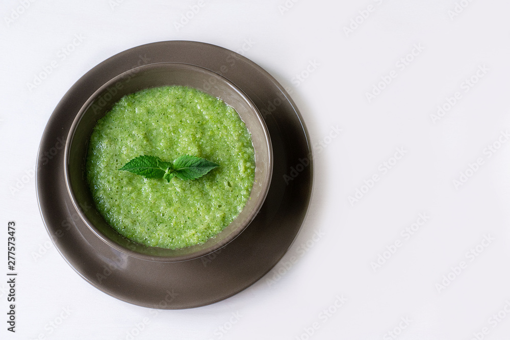Vegetarian soup of broccoli puree on a white background. The concept of healthy eating. Vegetarian soup of broccoli puree on a white background. The concept of healthy eating.