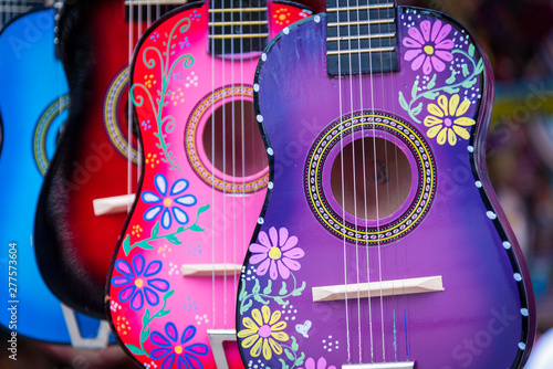 A group of colorful painted mexican made guitars