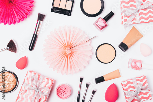 Pink flat lay background of makeup products