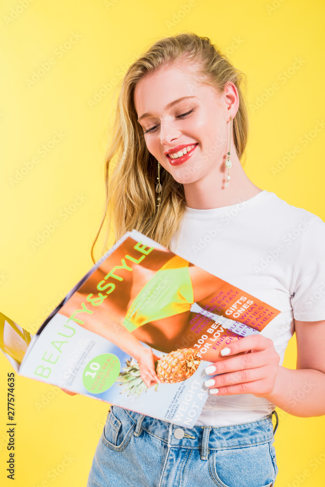 beautiful girl reading beauty and style magazine Isolated On yellow beautiful girl reading beauty and style magazine Isolated On yellow