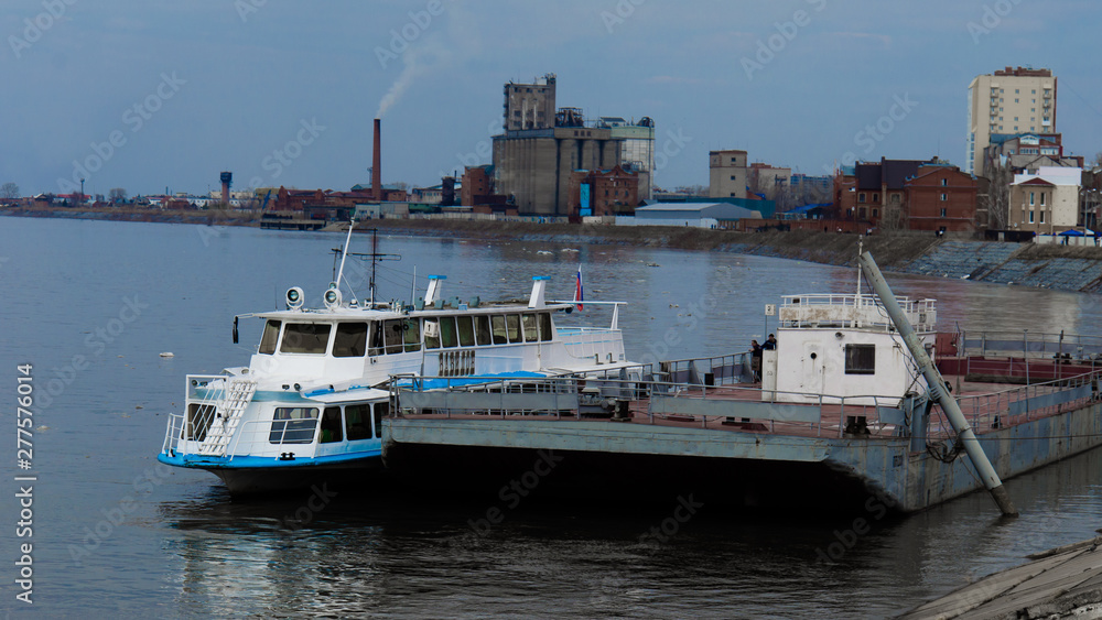 Ship with flags sailing on a river barge