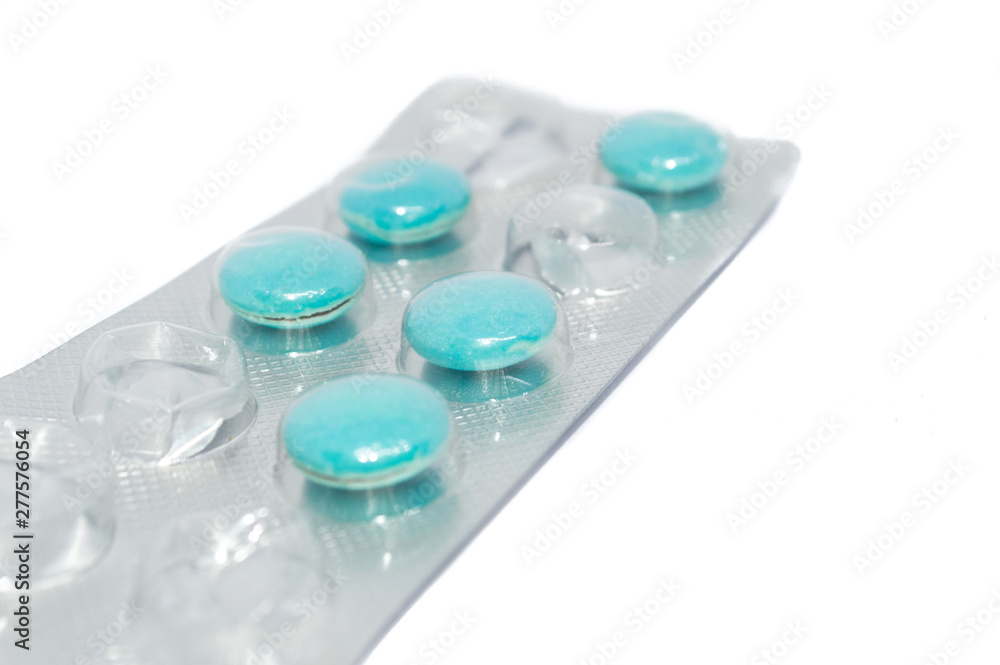 green pills inside the pack isolated on white background; health medicine concept green pills inside the pack isolated on white background; health medicine concept