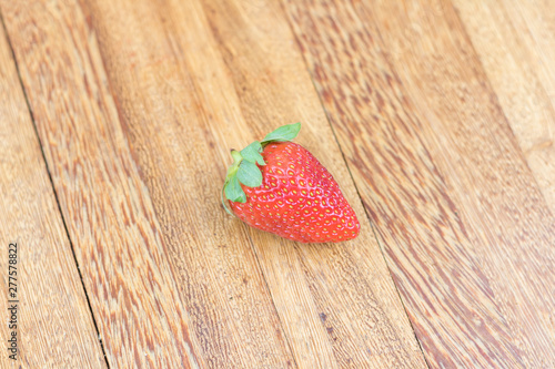 Close-up fresh strawberry. Wooden background.