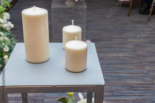 three decorative candles on an iron table