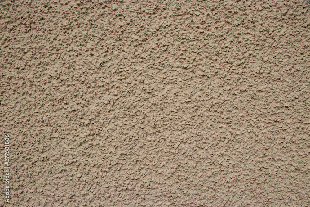 Beige painted stone pebble wall texture Beige painted stone pebble wall texture