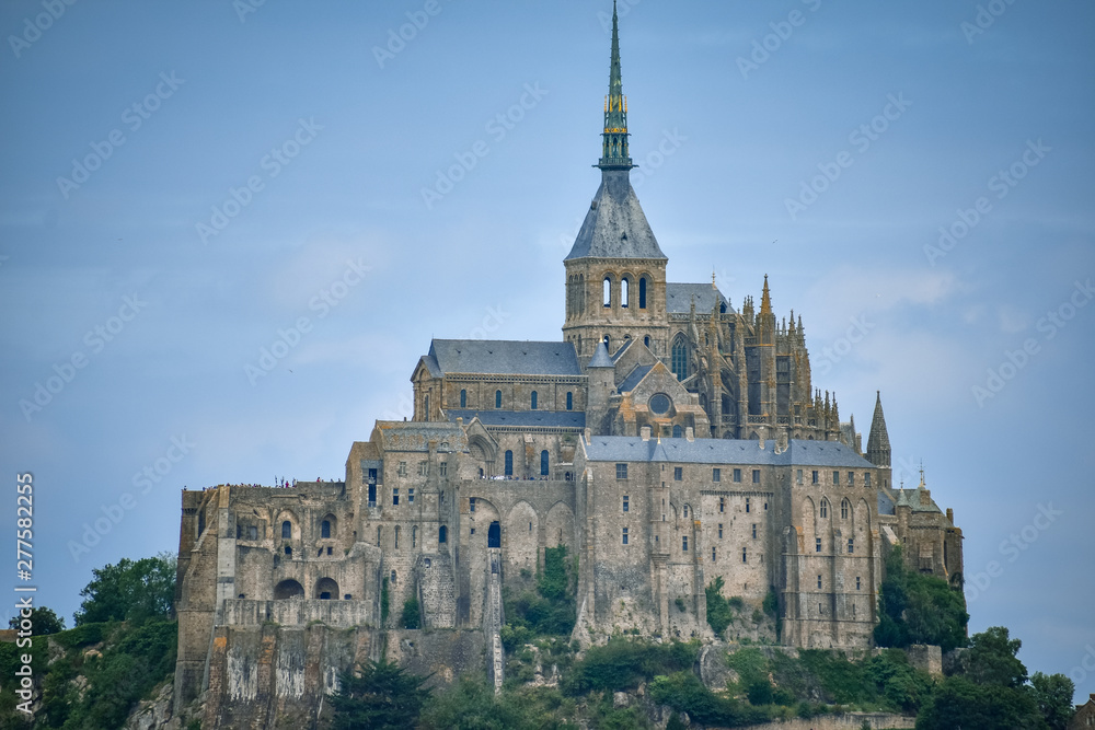 Close-up of Mont Saint Michel, France, in a blue cloudy sky.