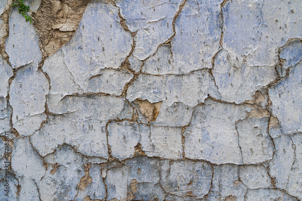 Obraz premium Old cracked parget (plaster) on a painted blue medieval wall of a house in Lefkara heritage village on Cyprus
