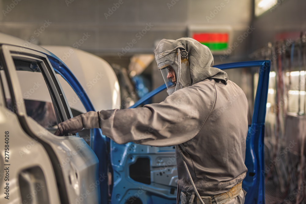employee body painting workshop carries out painting of the internal elements of the car. employee body painting workshop carries out painting of the internal elements of the car.