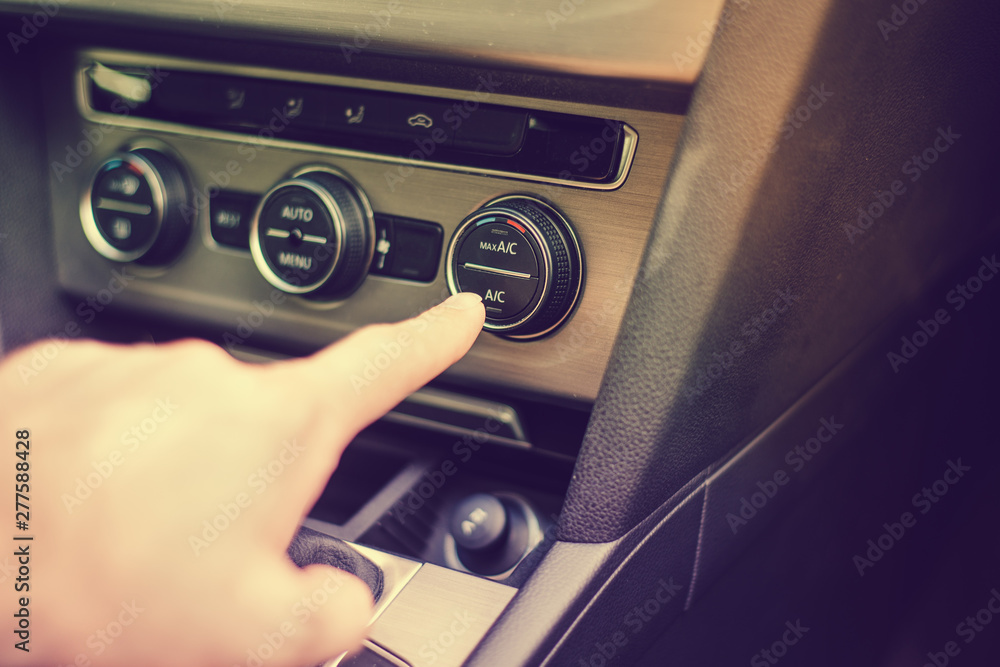 Turning the air conditioning on in the car. The concept of caring for