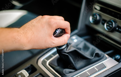 Hand of the driver on the gear knob in the car. Transport concept and manual transmission. Driving, transmission failure.