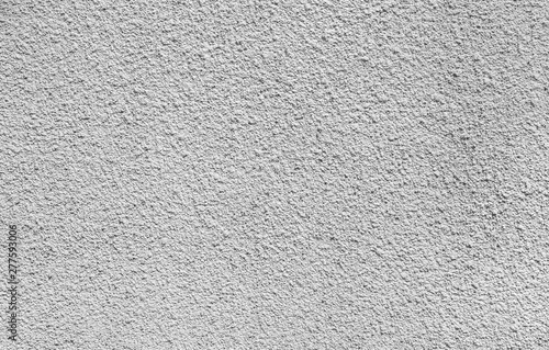 Plastered, painted, rough and white concrete or stone wall in black and white. High resolution full frame textured background.